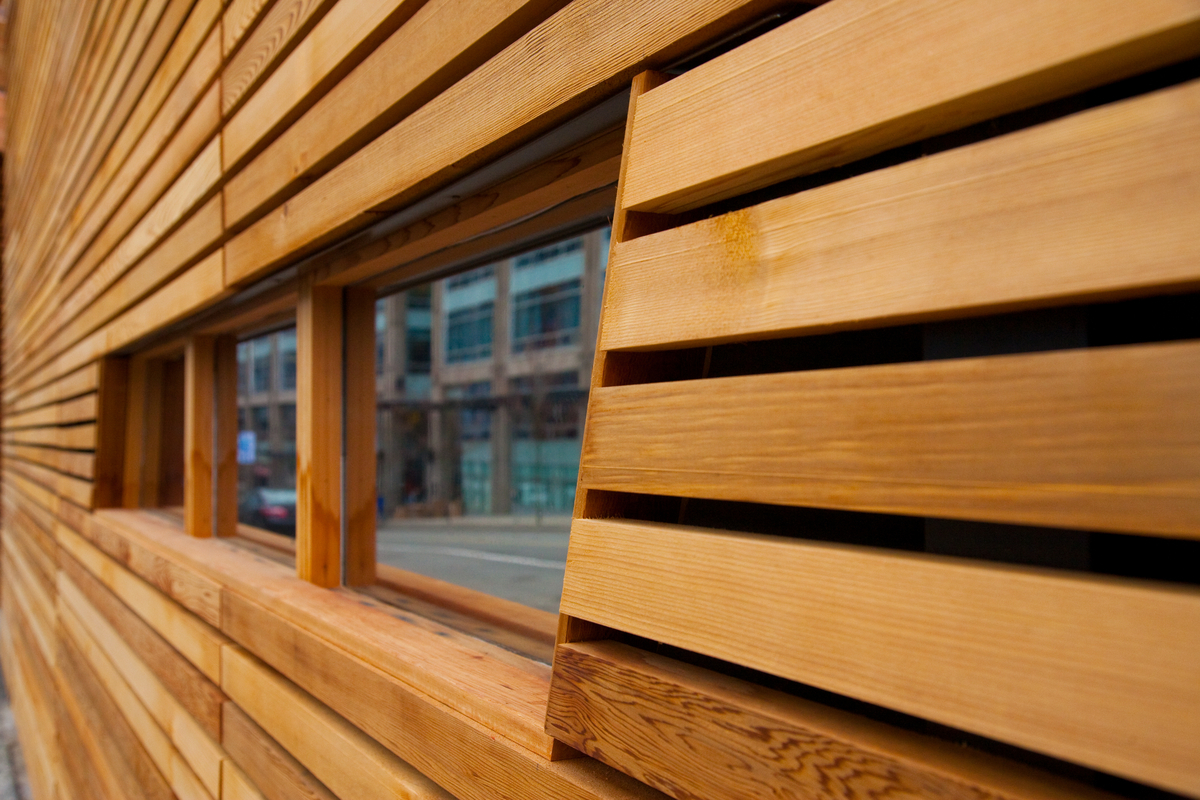 Exterior closeup view of exterior wood siding and window frame on Alberta House Plaza and Business Centre, shown as examples of exterior wood products